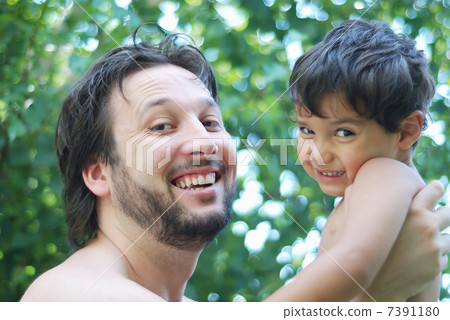 Lovely boy and his father holding him in hands in nature Lovely boy and his father holding him in hands in nature 7391180