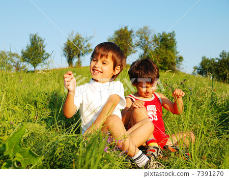 Little cute children on beautiful green field Little cute children on beautiful green field 7391270