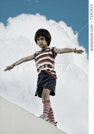 Kid walking and balancing on wall Kid walking and balancing on wall 7391453