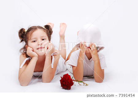 Beautiful scene of a girl and boy laying on ground Beautiful scene of a girl and boy laying on ground 7391454