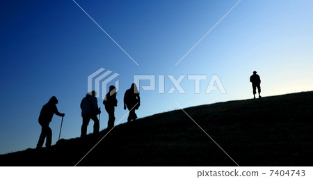 Group of tourists take to the mountains. Silhouette Group of tourists take to the mountains. Silhouette 7404743