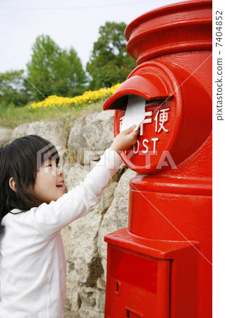 A girl putting a letter in the post A girl putting a letter in the post 7404852