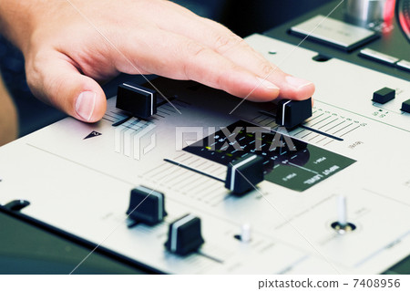 Hand of a dj adjusting the crossfader 7408956