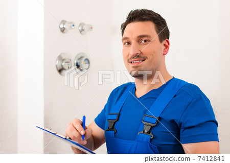 Technician reading the water meter 7412841
