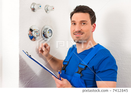 Technician reading the water meter 7412845