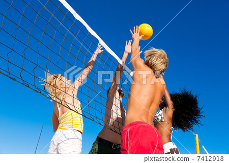 Friends playing beach volleyball Friends playing beach volleyball 7412918