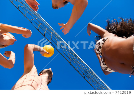 Friends playing beach volleyball Friends playing beach volleyball 7412919
