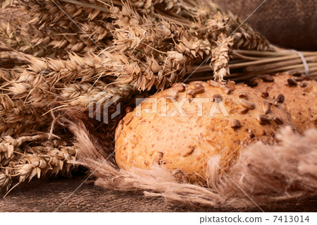 Loaf of bread and wheat ears still life 7413014