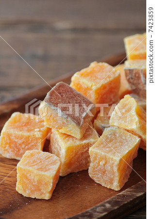 Sweet potato amanatto on a wooden plate, Japanese confectionery Sweet potato amanatto on a wooden plate, Japanese confectionery 7423859