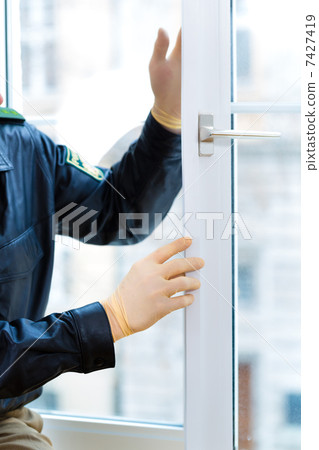 Police officer at crime scene after burglary Police officer at crime scene after burglary 7427419