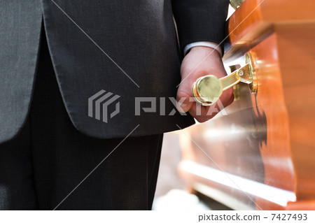 coffin bearer carrying casket at funeral 7427493
