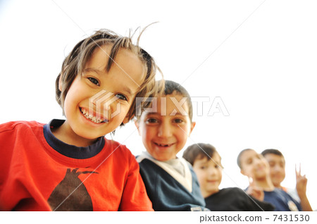 Below view of happy children embracing each other and smiling at camera Below view of happy children embracing each other and smiling at camera 7431530