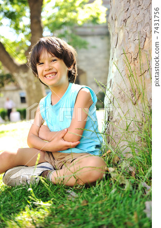 Kid under the tree in park Kid under the tree in park 7431756