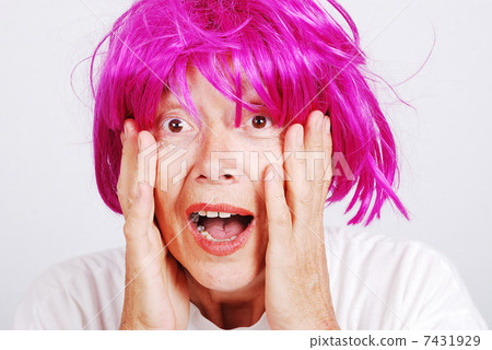 Senior woman with pink hair and facial gesture Senior woman with pink hair and facial gesture 7431929