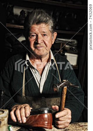 Old man, shoemaker, repairing old handmade shoe in his workshop Old man, shoemaker, repairing old handmade shoe in his workshop 7432069