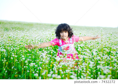 Adorable girl on green grass 7432272