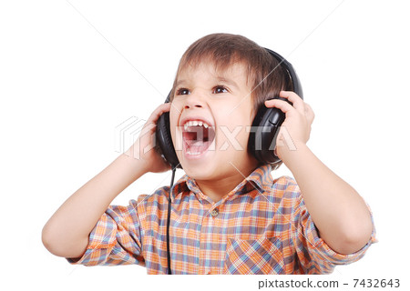 Little nice boy listening to music with peaceful expression on face 7432643