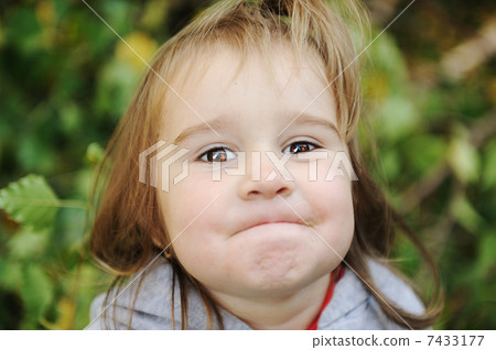 Happy childhood outdoor, happy faces between the leaves of the trees in forest or park, look for more in my porftolio Happy childhood outdoor, happy faces between the leaves of the trees in forest or park, look for more in my porftolio 7433177
