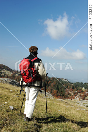 Female on the peak of mountain. Landscape composition. 7433223