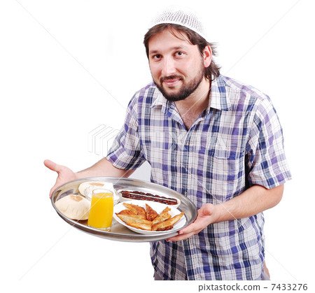 Young muslim man with prepared food for iftar in Ramadan Young muslim man with prepared food for iftar in Ramadan 7433276