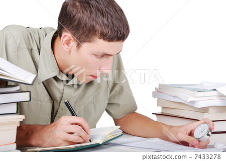 Young man writting on desk with books Young man writting on desk with books 7433278