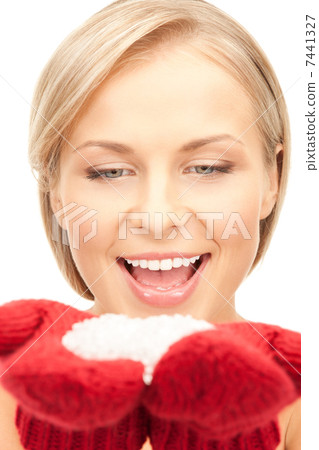 beautiful woman in red mittens with snow 7441327