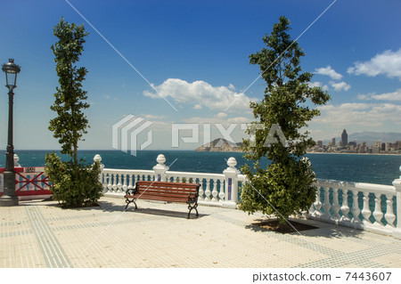 The skyline of Benidorm. Bench on balustrade and skyscrapers. The skyline of Benidorm. Bench on balustrade and skyscrapers. 7443607