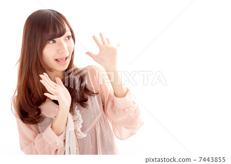 A cute girl that looks surprised with wide open hands 7443855