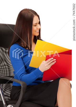 young businesswoman with folders sitting in chair young businesswoman with folders sitting in chair 7447682