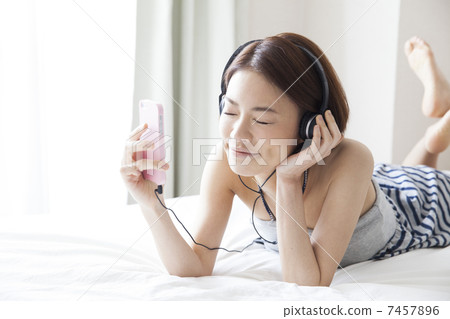 A woman listening to music 7457896