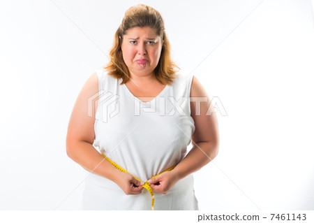 Woman measuring her waist with tape Woman measuring her waist with tape 7461143