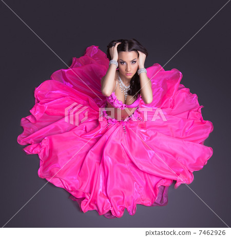 Pretty dancer in pink costume sitting on floor Pretty dancer in pink costume sitting on floor 7462926