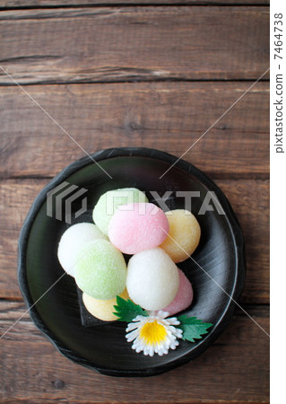 Colorful Tsukimi Dango served on a black wooden plate Colorful Tsukimi Dango served on a black wooden plate 7464738