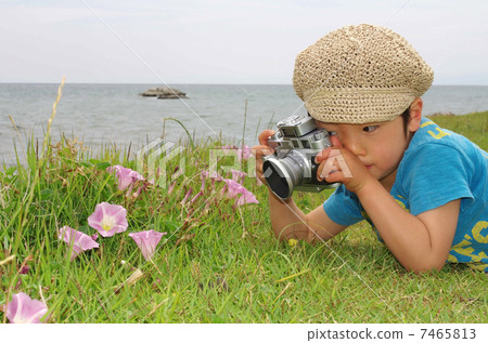 A small photographer shooting with a rangefinder camera 7465813