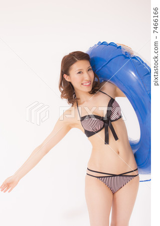 A woman in a bathing suit with a floating ring A woman in a bathing suit with a floating ring 7466166