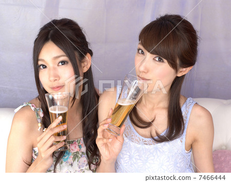 Two young women with beer glasses Two young women with beer glasses 7466444