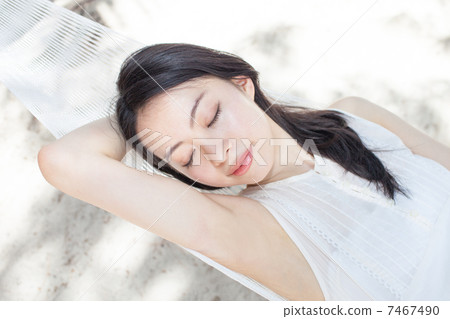 A woman sleeping in a hammock 7467490