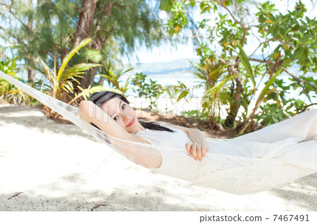 A woman sleeping in a hammock A woman sleeping in a hammock 7467491