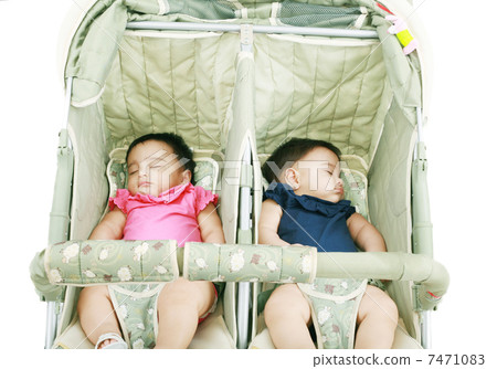twins sleeping in their stroller 7471083