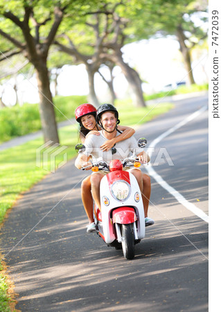 Scooter - couple driving in summer Scooter - couple driving in summer 7472039