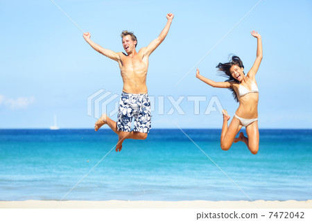 Beach people - happy couple jumping Beach people - happy couple jumping 7472042