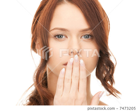 woman with hand over mouth 7473205