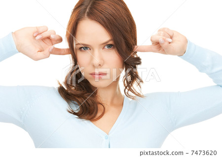 woman with fingers in ears 7473620