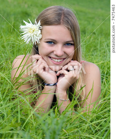 beautiful girl lying on grass field 7475463