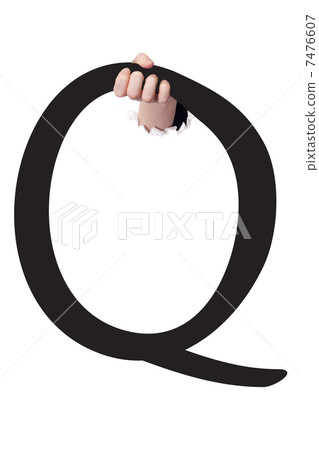 Hand breaking paper surface holding letter 'Q' 7476607