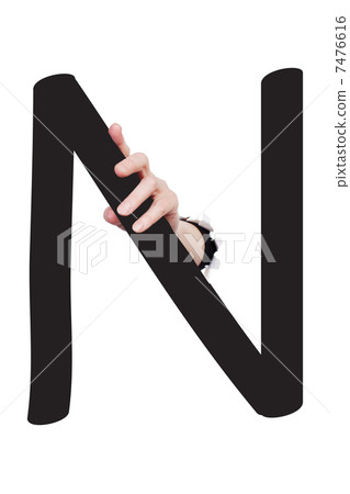 Hand breaking paper surface holding letter 'N' 7476616