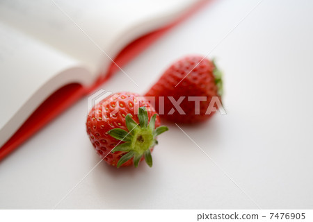 A book and two strawberries, bright copy space 7476905