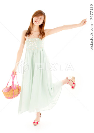 A young girl who is happy with a basket with a long dress 7477129