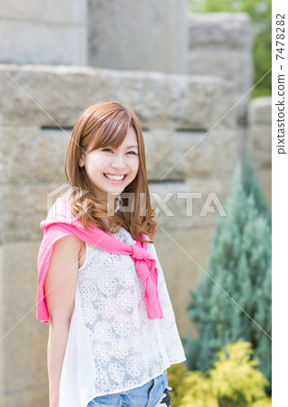 A young woman smiling outdoors A young woman smiling outdoors 7478282