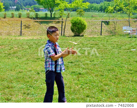 Boy and Takebo Dobo A Boy with a wooden Japanese toy that flies 7482008